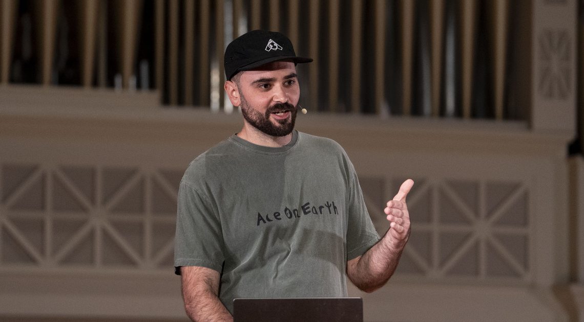 Austin Pereira speaking on stage