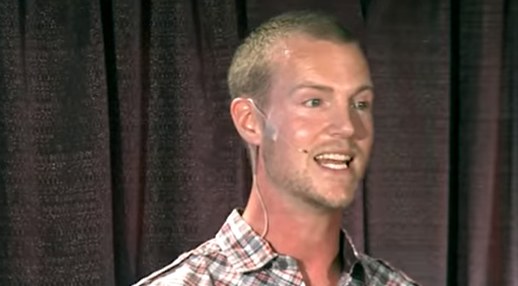 Taylor Conroy speaking on a TEDx stage